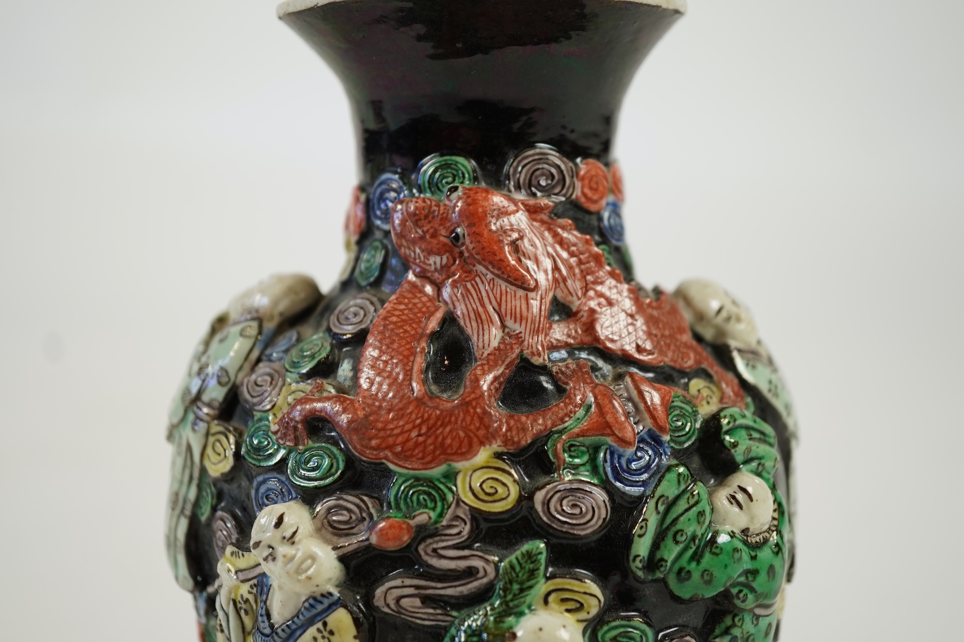 A Chinese enamelled biscuit ‘eighteen Luohan’ vase, 19th century